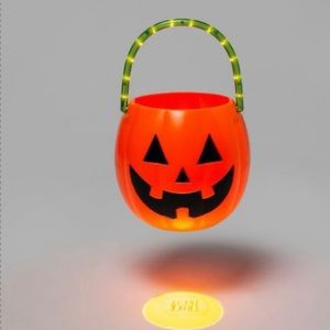 LED trick or treat pail illuminated handle projects “trick or treat” on ground